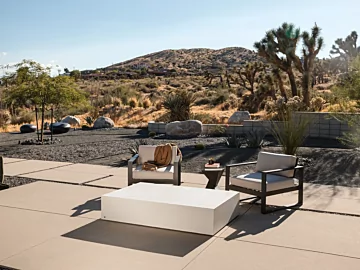 Blinde Design Move 65 Coffee Table in bone concrete anchors Starfire garden patio, delivering modern outdoor coffee table focal point.