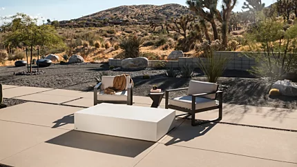 Blinde Design Move 65 Coffee Table in bone concrete anchors Starfire garden patio, delivering modern outdoor coffee table focal point.